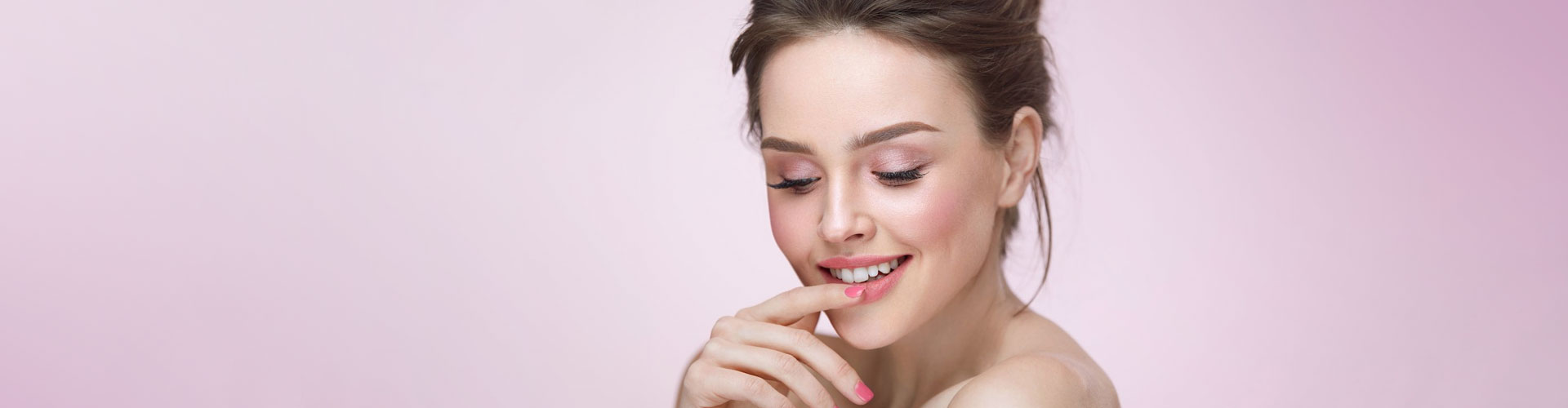 A close-up photo of a smiling woman with short brown hair.